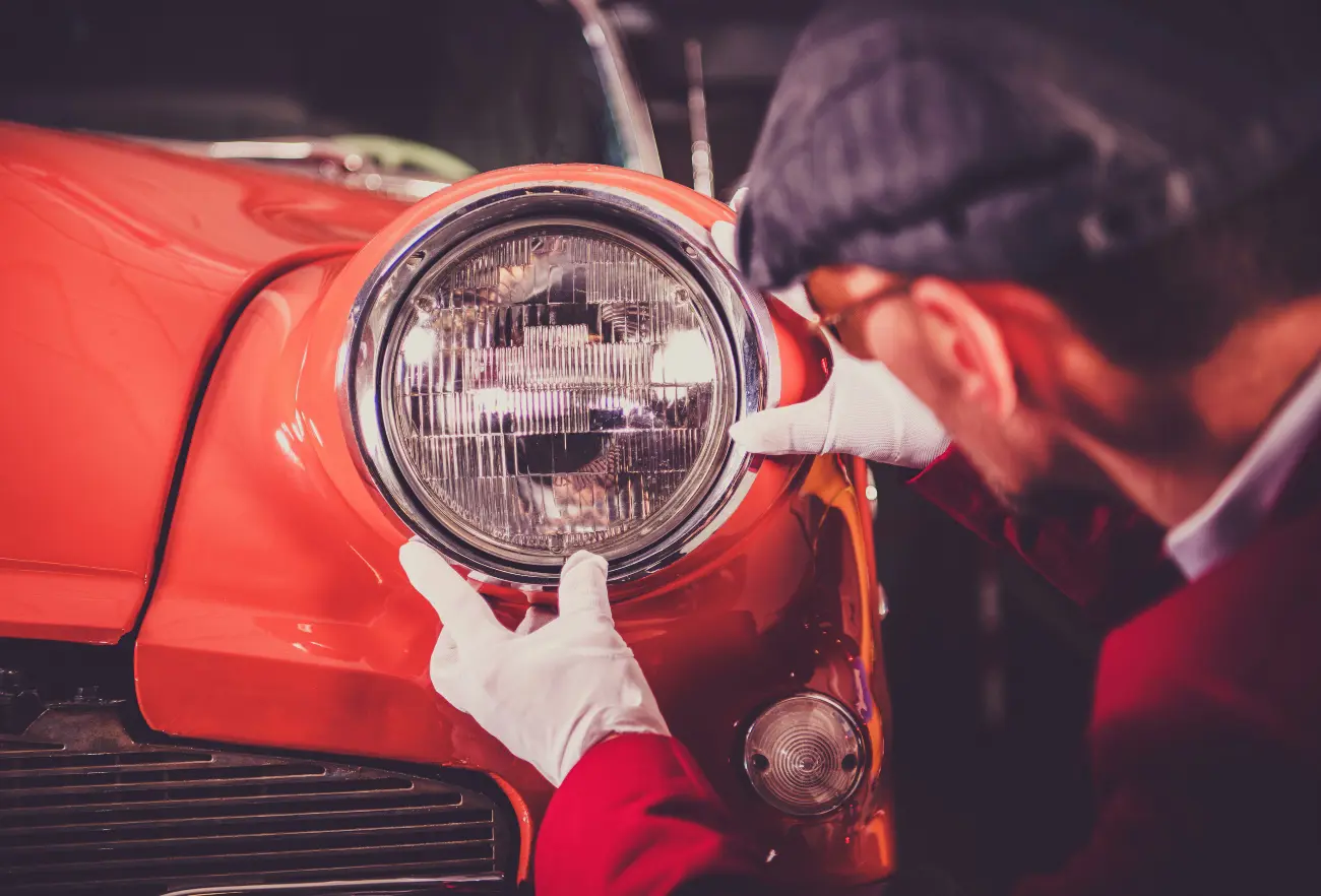 man restoring classic car