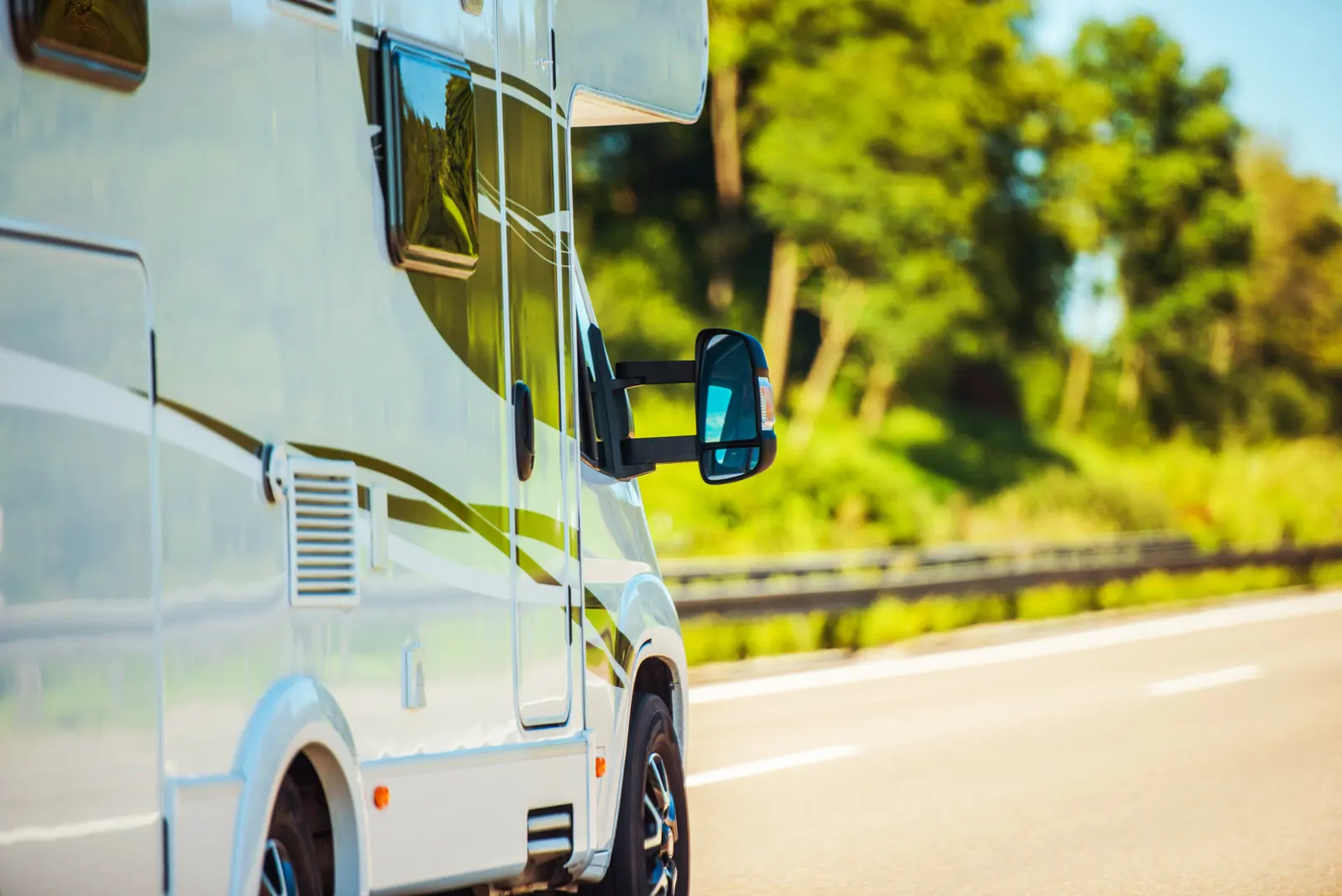 A motrhome travelling along a motorway on a sunny day