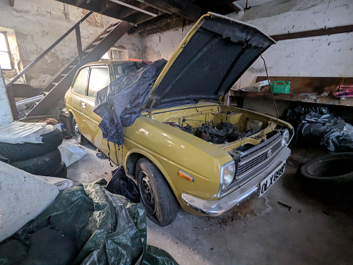 Yellow car with bonnet open