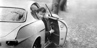 Man looking back from car