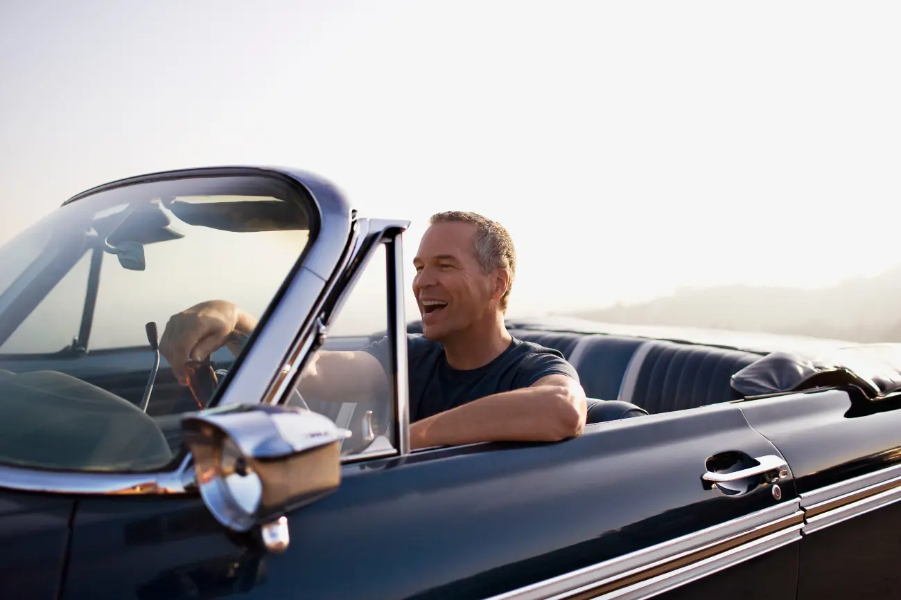 man in cabriolet car