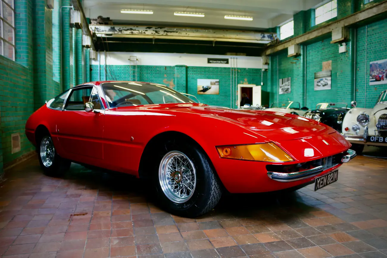 red classic car in a showroom