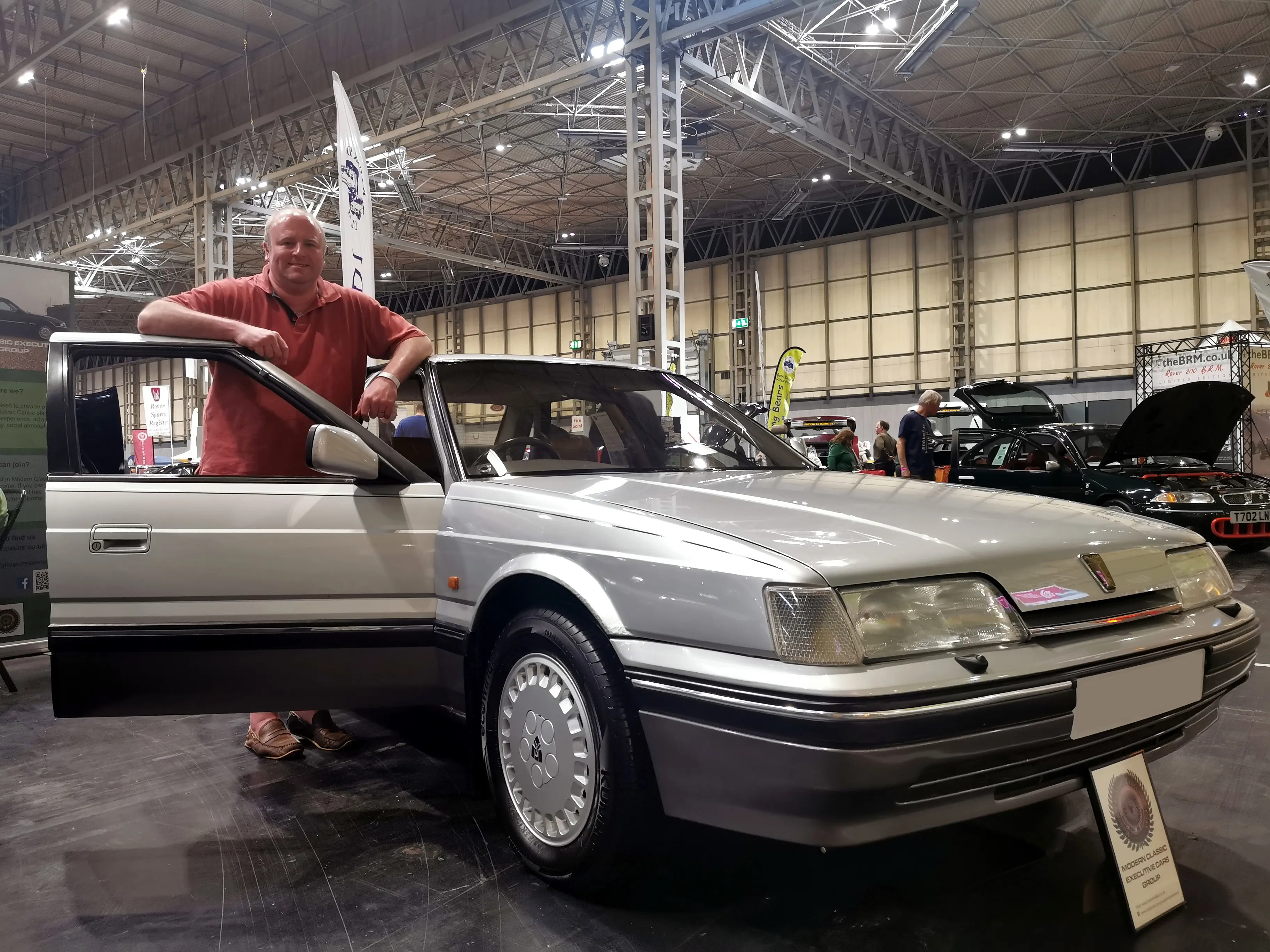 Man with silver car